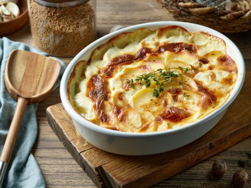 Scalloped potatoes on a wooden board