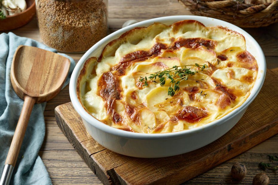Scalloped potatoes on a wooden board