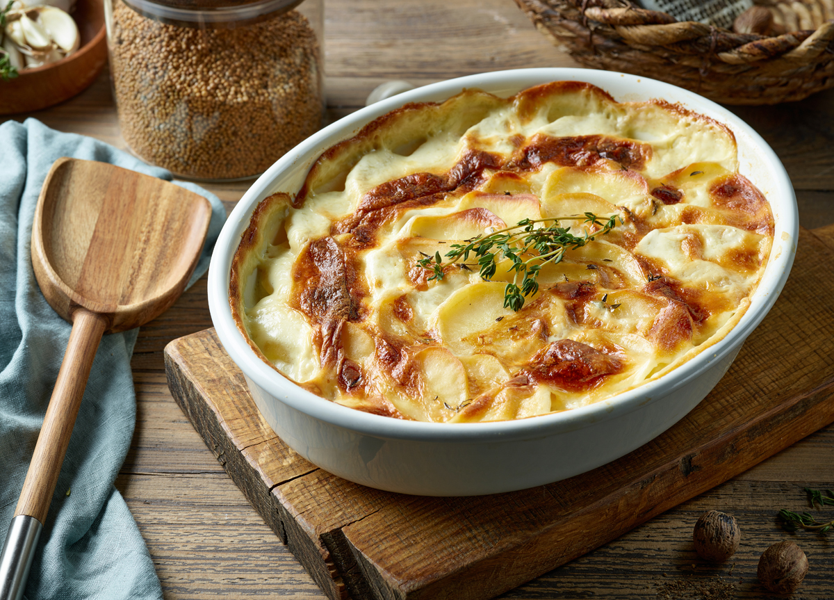 Scalloped potatoes on a wooden board