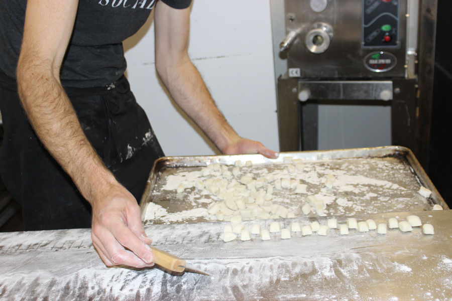Holger pushes the completed Gnocchi onto the tray for drying