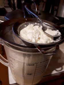 Ricotta draining into cup