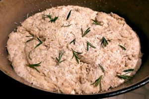 Before baking, with rosemary, rock salt, and sesame seeds.