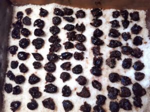 Pitted olives drying on a bed of salt