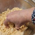 Mixing the marzipan crumble in a bowl