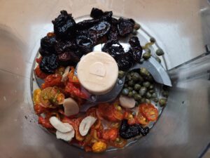 Tapenade ingredients in processor