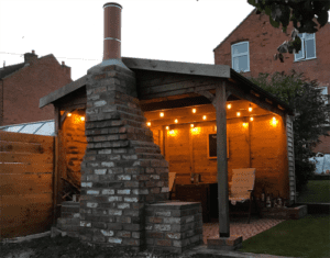 Golden light on the outdoor living room attached to Andy's outdoor kitchen