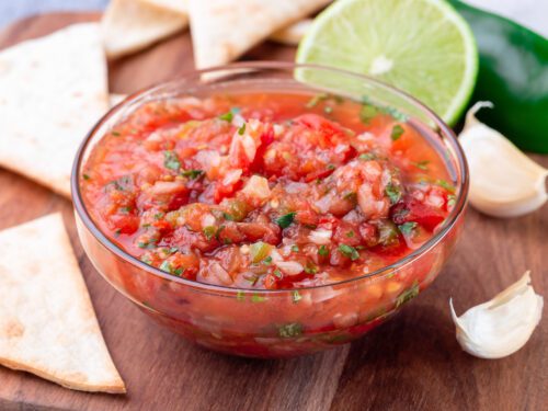 Salsa Asada with roasted vegetables, served with a tortilla chips and lime, horizontalSalsa Asada