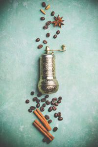 Top view of vintage manual coffee grinder, coffee beans and spices,