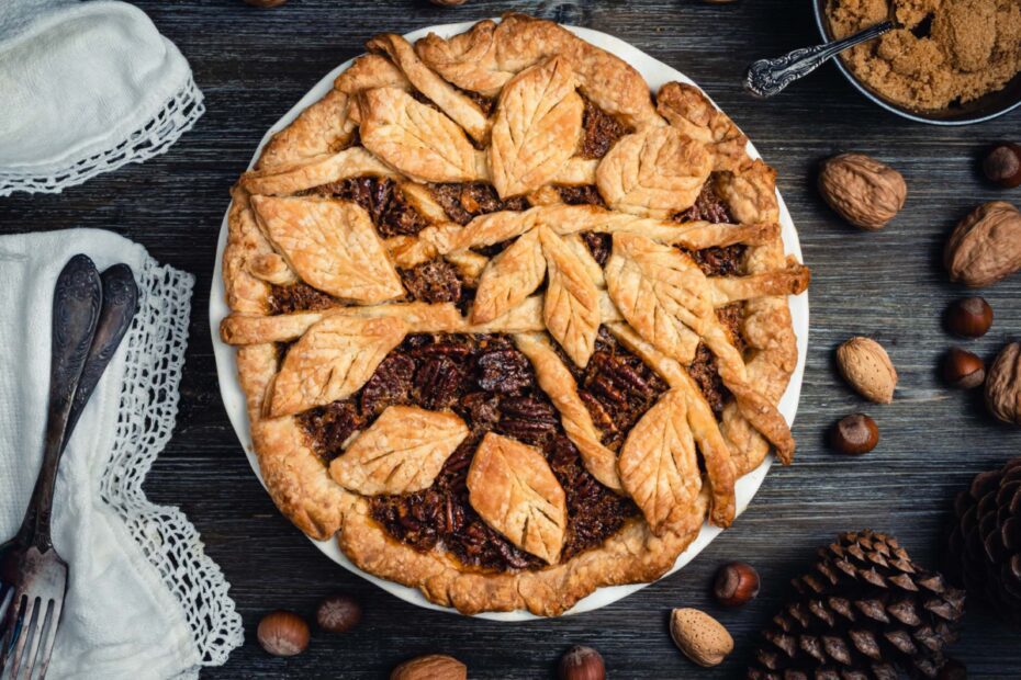 Freshly baked pecan pie with leaves ornament.
